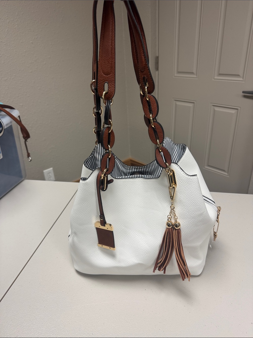 White and Brown Leather-Accent Tote Bag with Tassel